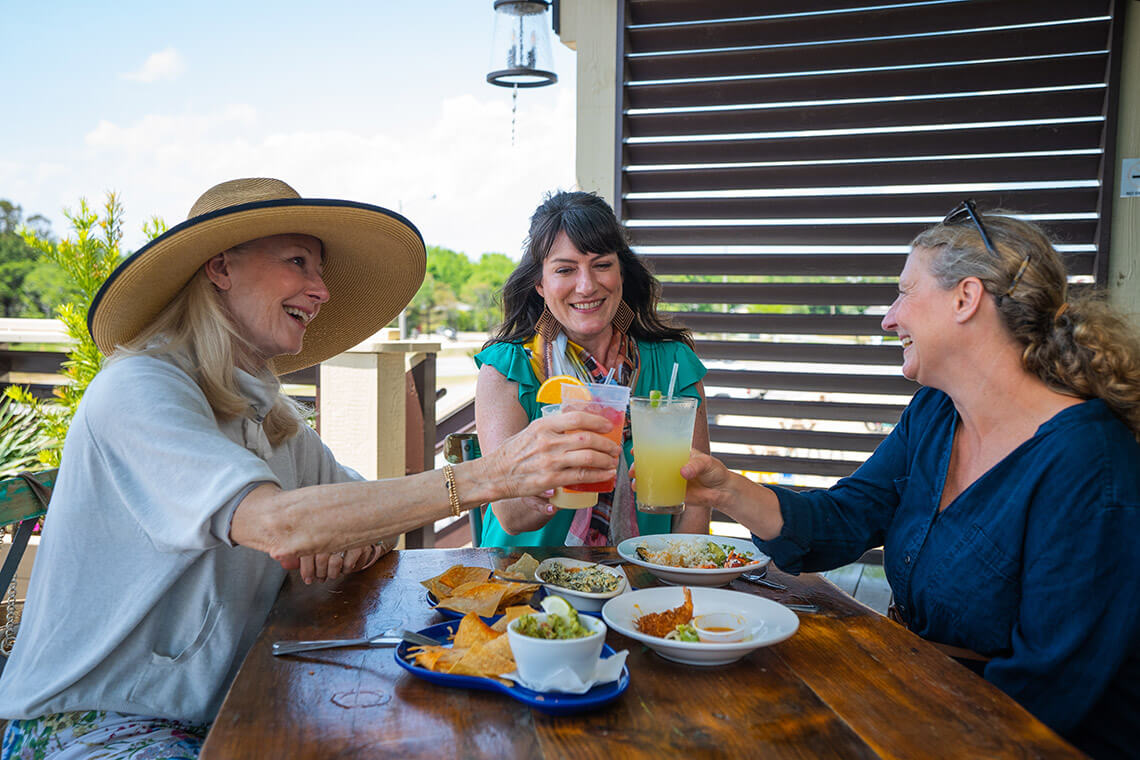Ladies toast drinks in at Bernie's Brother in Corolla.