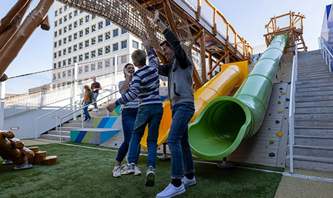 Kid with parents at the bottom of slide