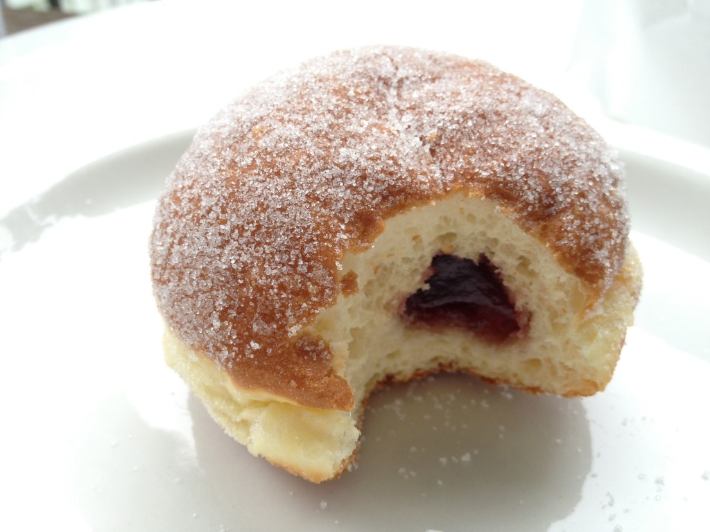 The Berliners are raised yeast doughnuts filled with black raspberry jam and coated in sugar.