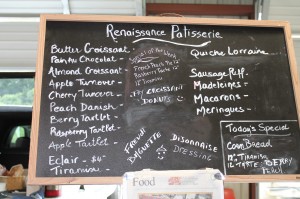 A chalkboard at the Gastonia Farmers Market lists items made by Sylvain Rivet, chef and owner of Renaissance Patisserie.