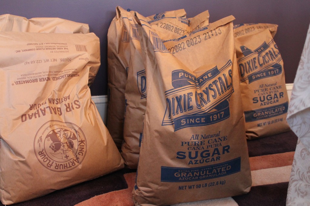 Commercial-size bags of King Arthur flour and Dixie Crystals sugar rest in Claire Putterman’s dining room in Charlotte for use in her muffins.