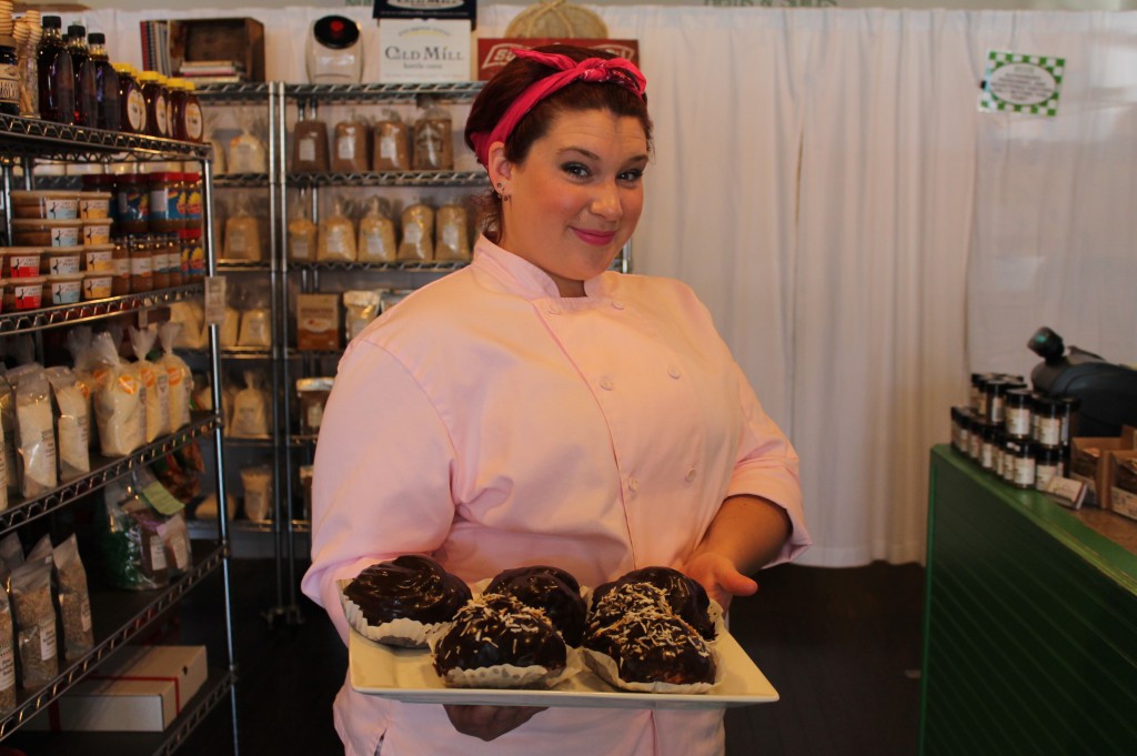 Emily Divers of See Jane Bake shows off a tray of her éclairs at the Provisions by Sandy Creek store in Waxhaw.