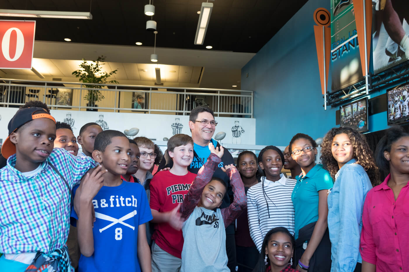 Panthers coach Ron Rivera poses for a quick picture with academy students before a live broadcast of Panther Talk.