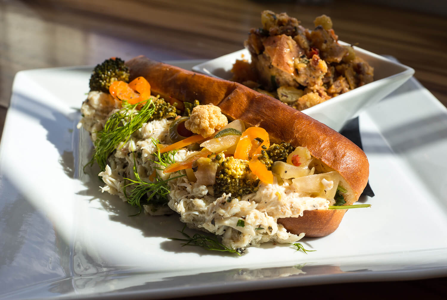 A buttery brioche roll is topped with lump crab, made bright by spiced lemon mayonnaise.