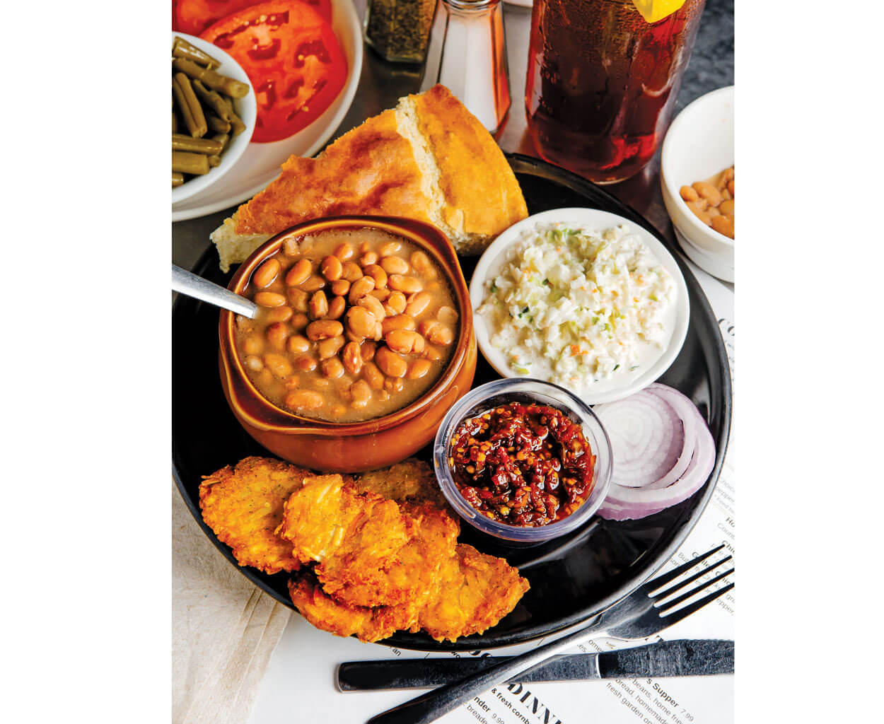 One of the most popular dishes at Genia Hayes Peterson’s diner is the “Poorman’s Supper”: pinto beans, cornbread, coleslaw, and potato cakes, crowned with spicy pepper relish.