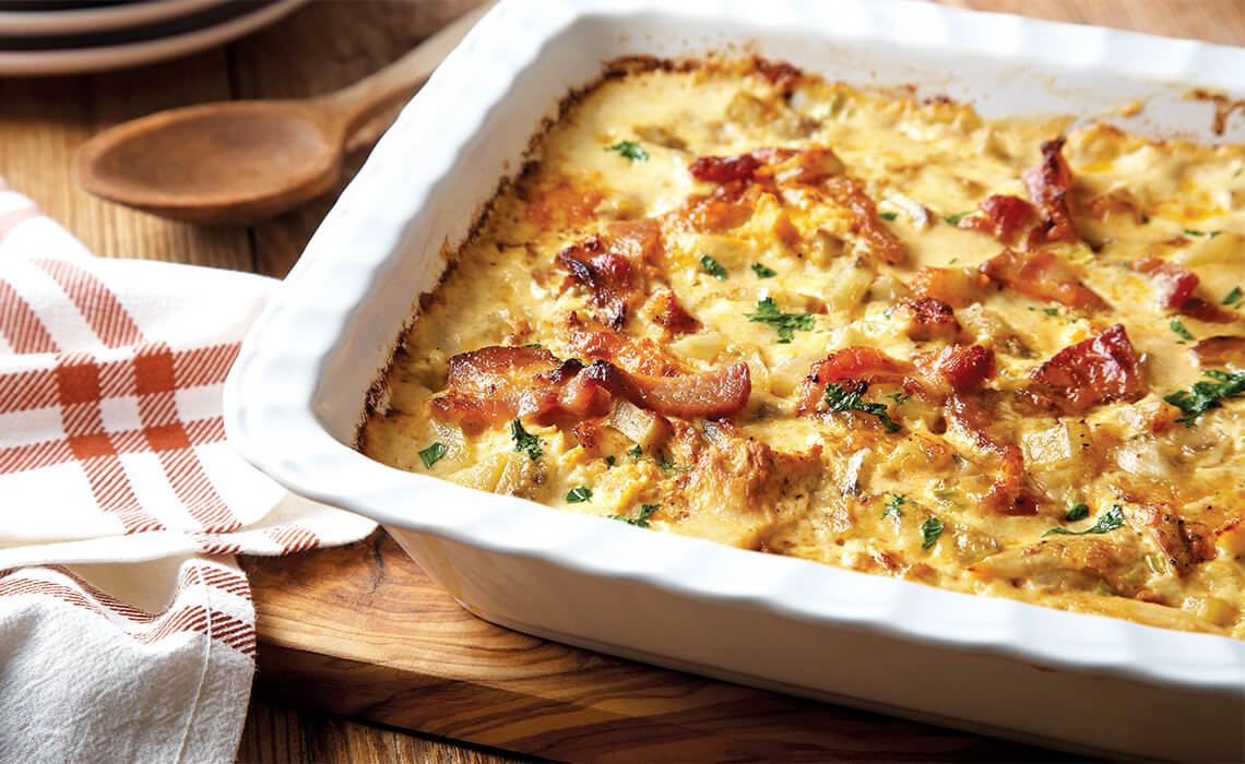Loaded chicken and potato casserole topped with bacon.