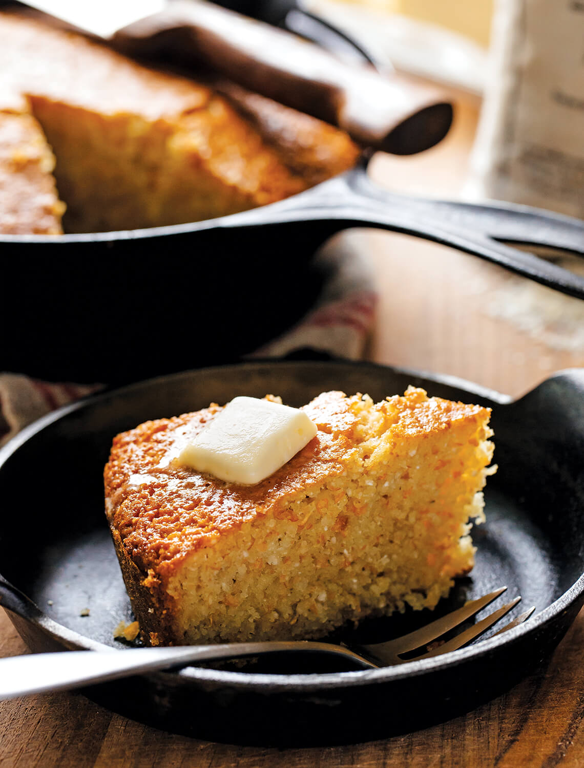 Skillet of cornbread with butter, one of Our State's most popular November recipes.