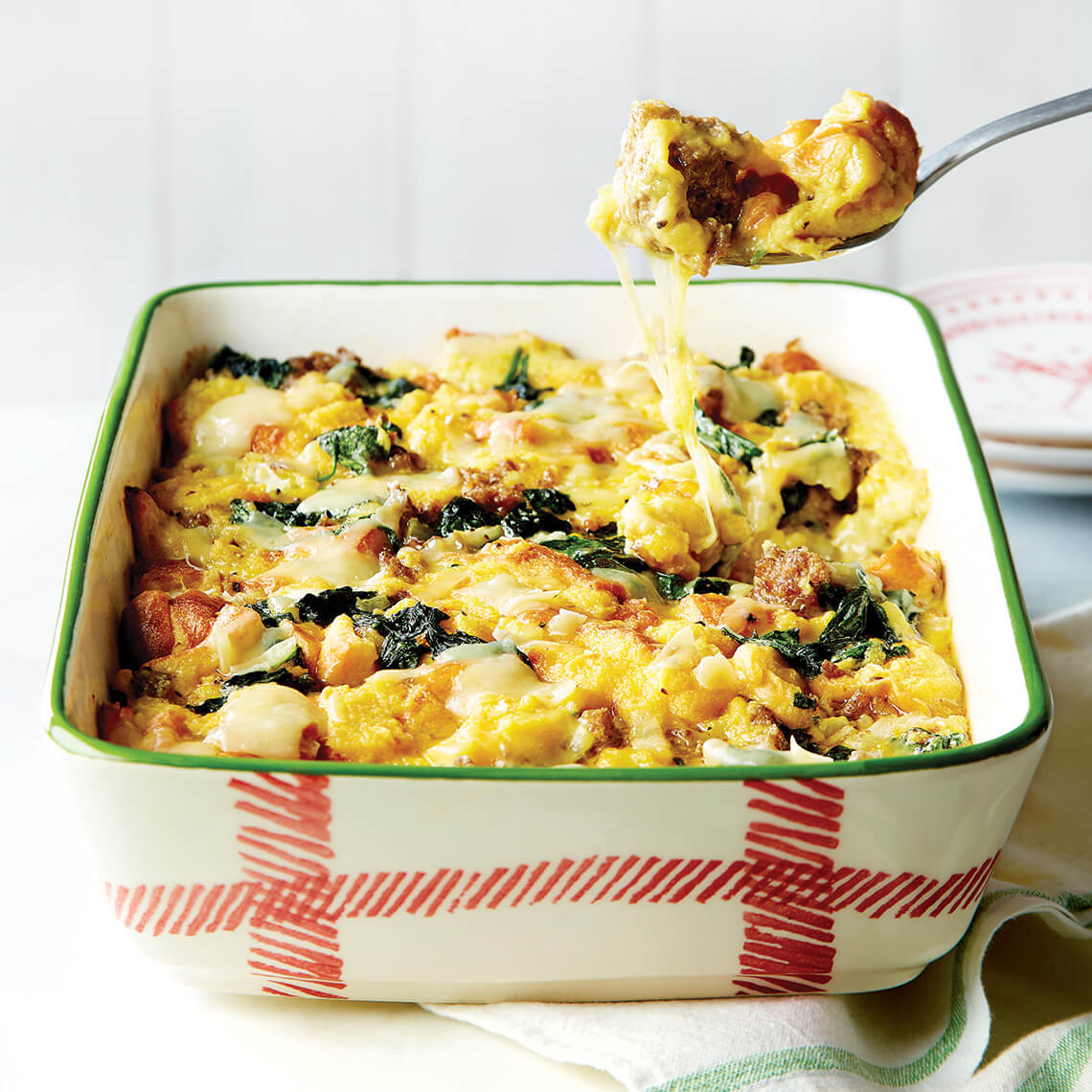 Casserole dish of spinach and sausage bread pudding