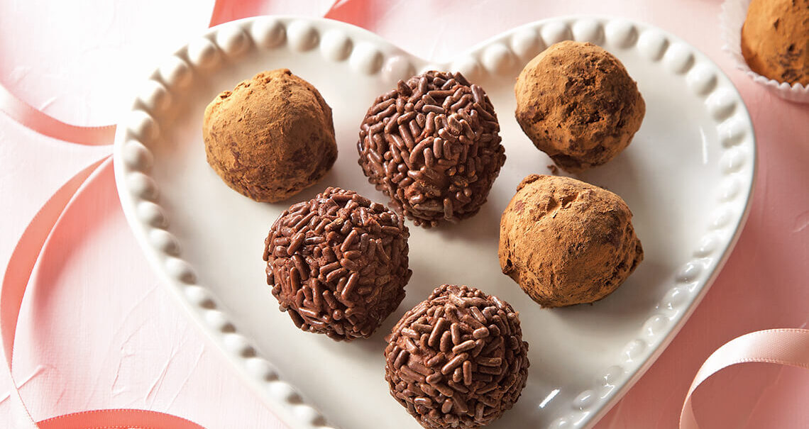 Chocolate truffles on a heart shape plate.