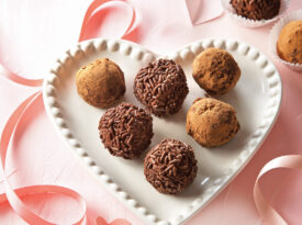 Chocolate truffles on a heart shape plate.