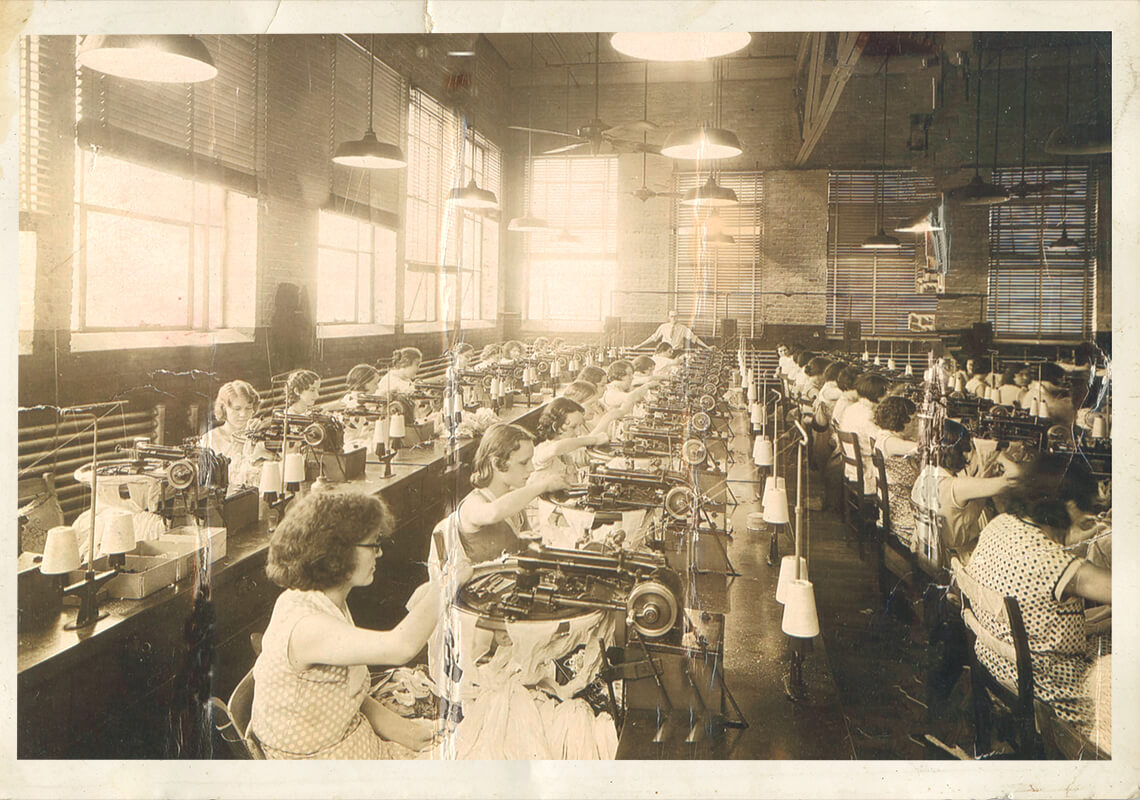 Old factory photo with women sewing hosiery.