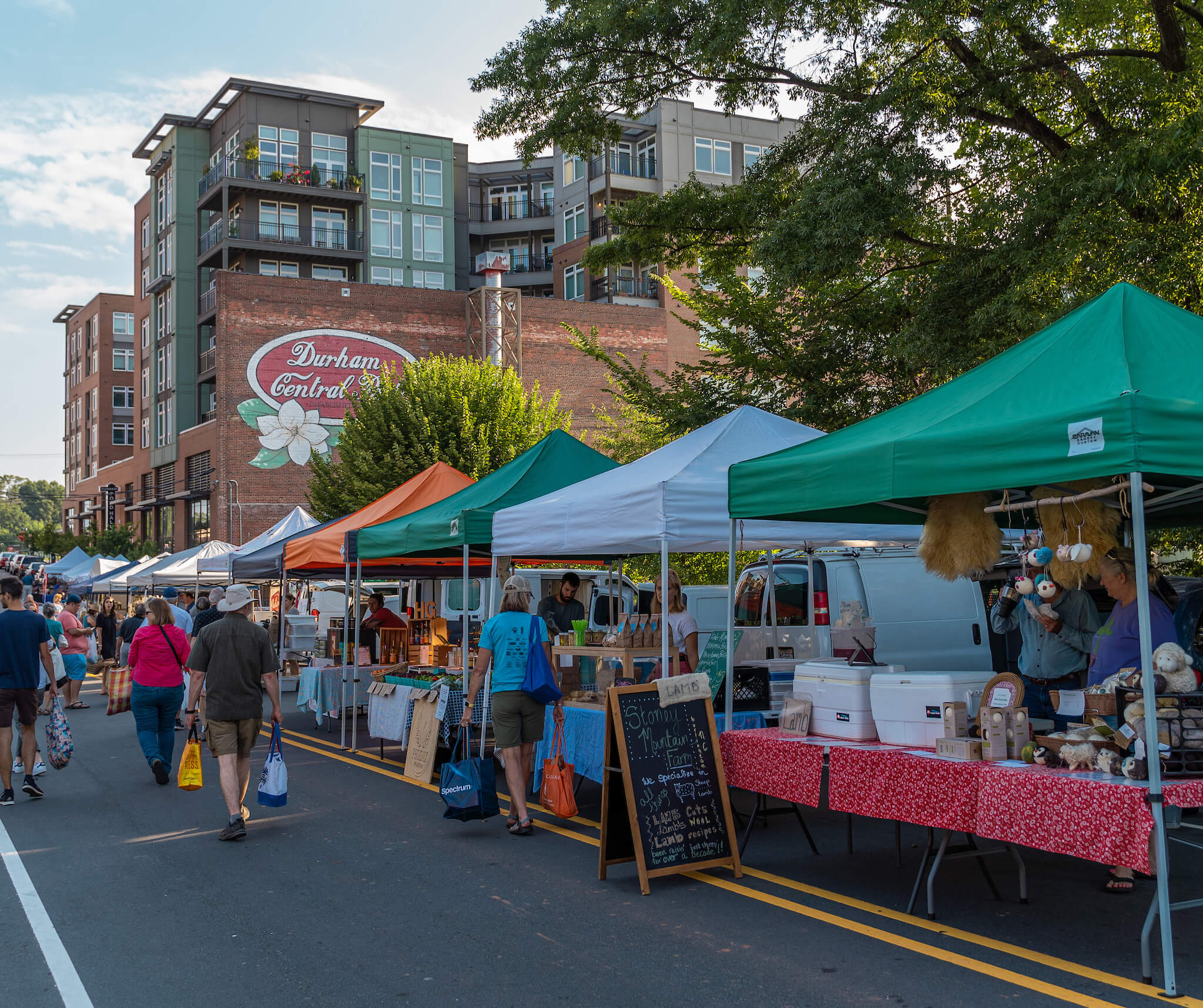 Rows of tents attract shoppers at the weekly Durham Farmers Market.