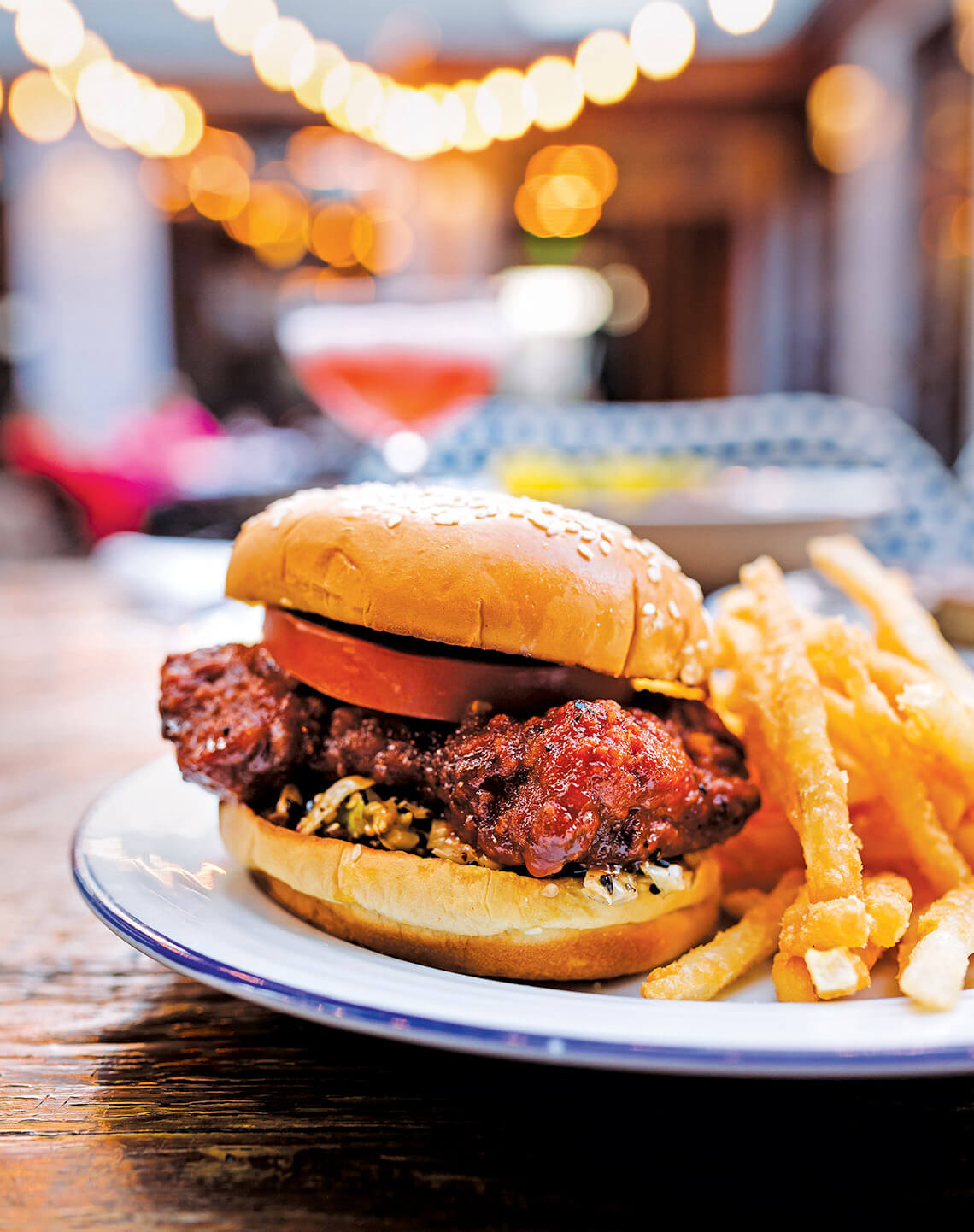 Close-up picture of spicy chicken sandwich with fries.