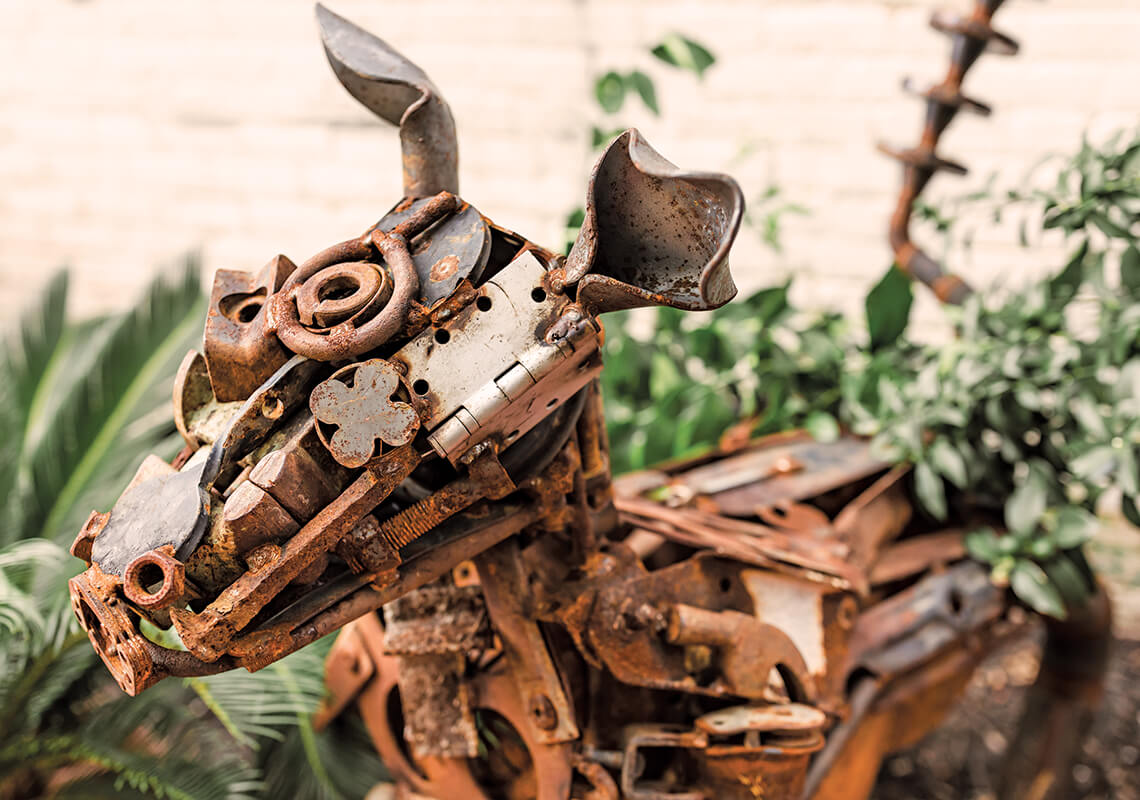Close-up of scrap metal dog sculpture.