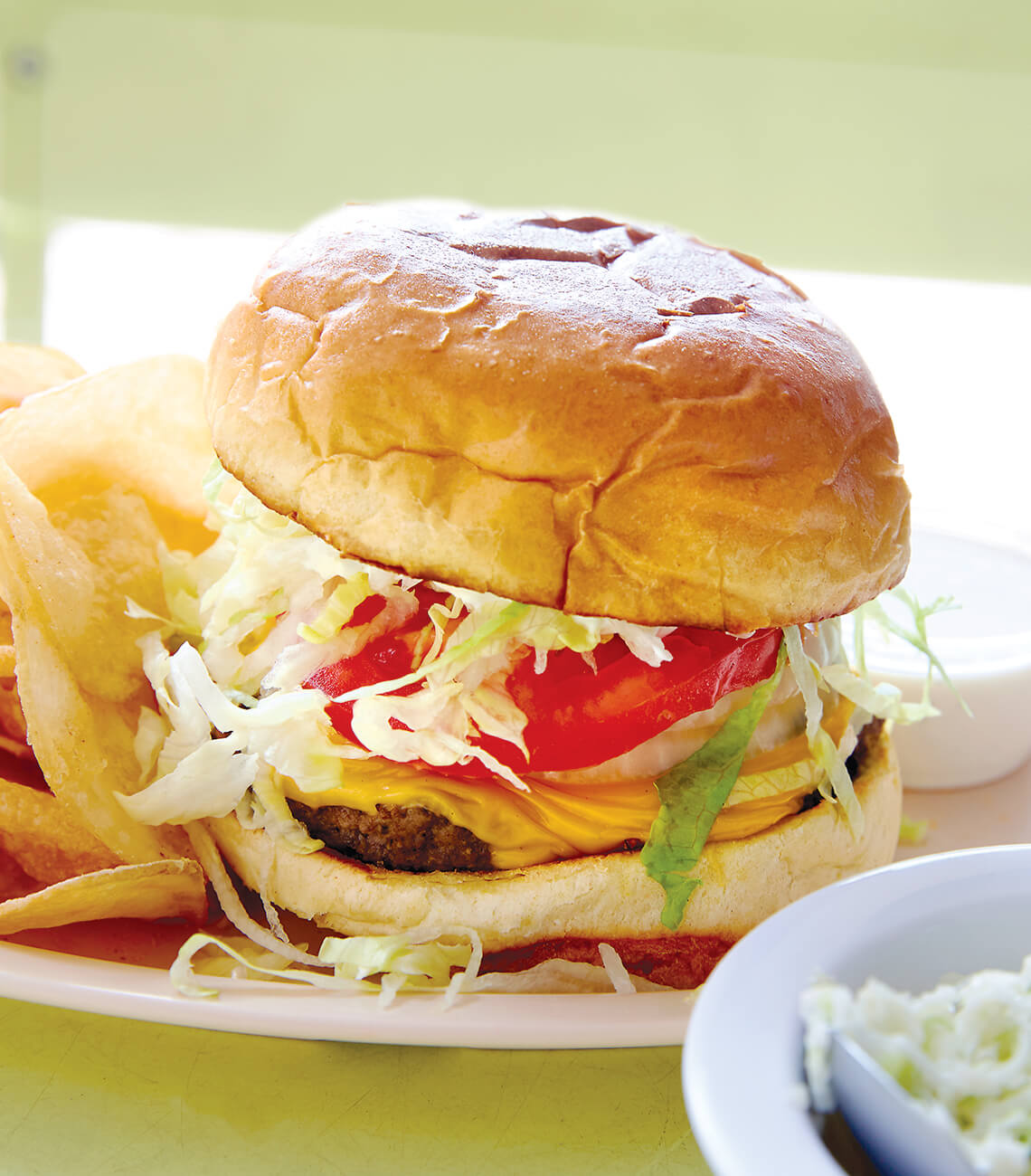 Burger and fries on a plate.