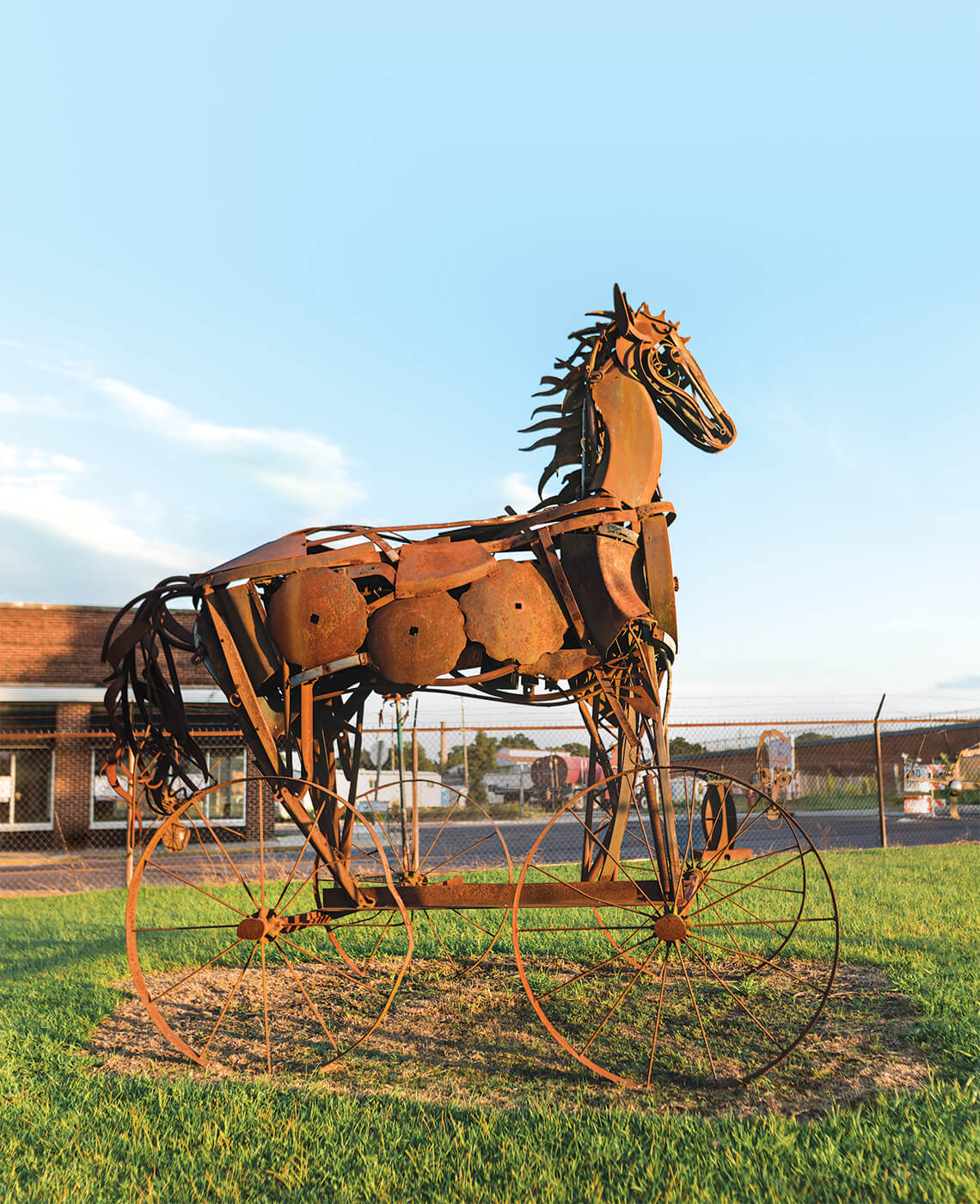 Large metal horse with wheels.