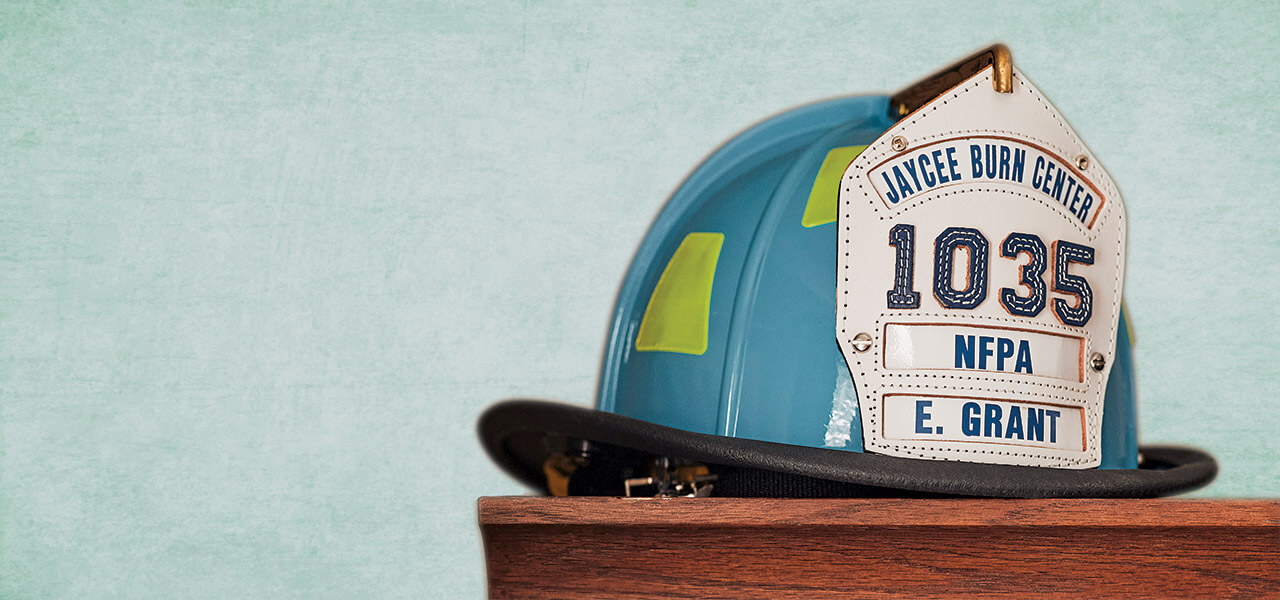 Ernest Grant's firefighter helmet sits atop wooden furniture.