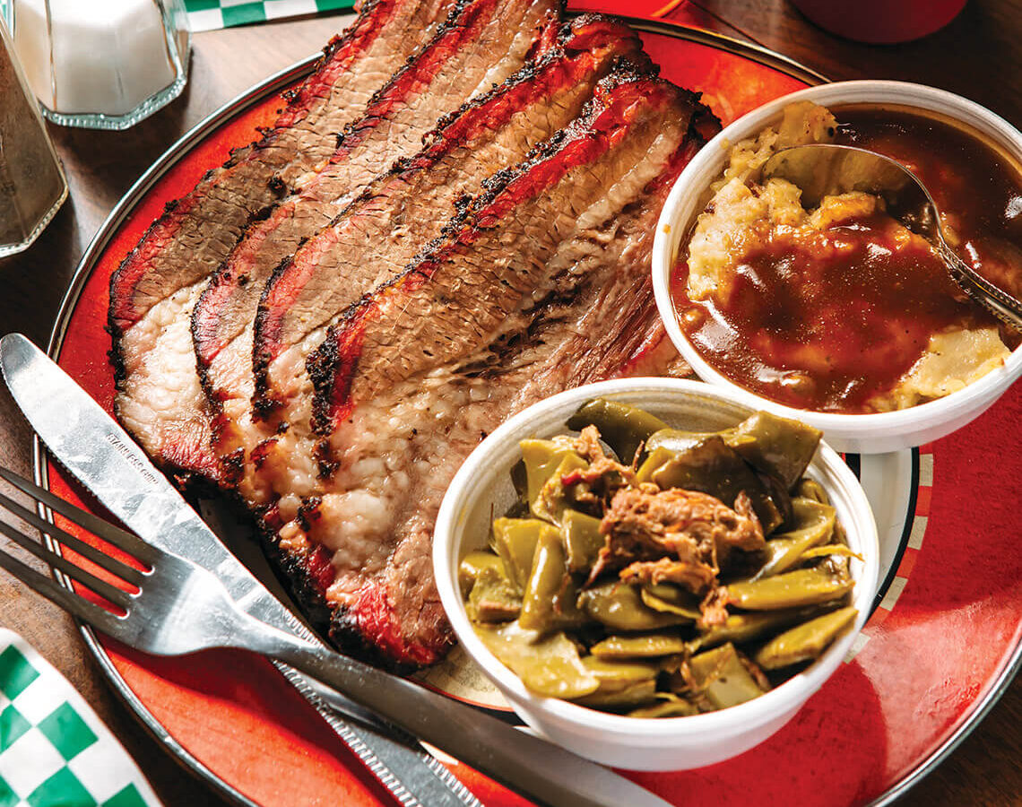 Sliced brisket and sides at The Honey Hog.