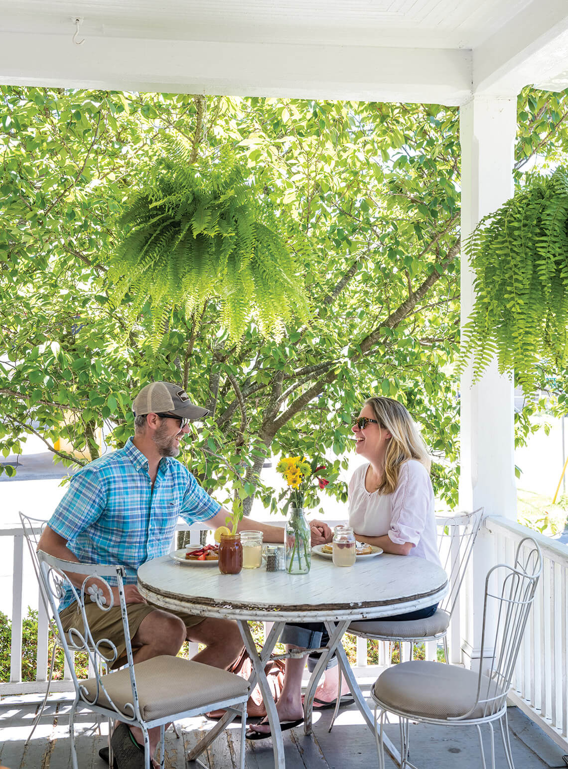 Two people having brunch outside on porch of Louise's Kitchen.