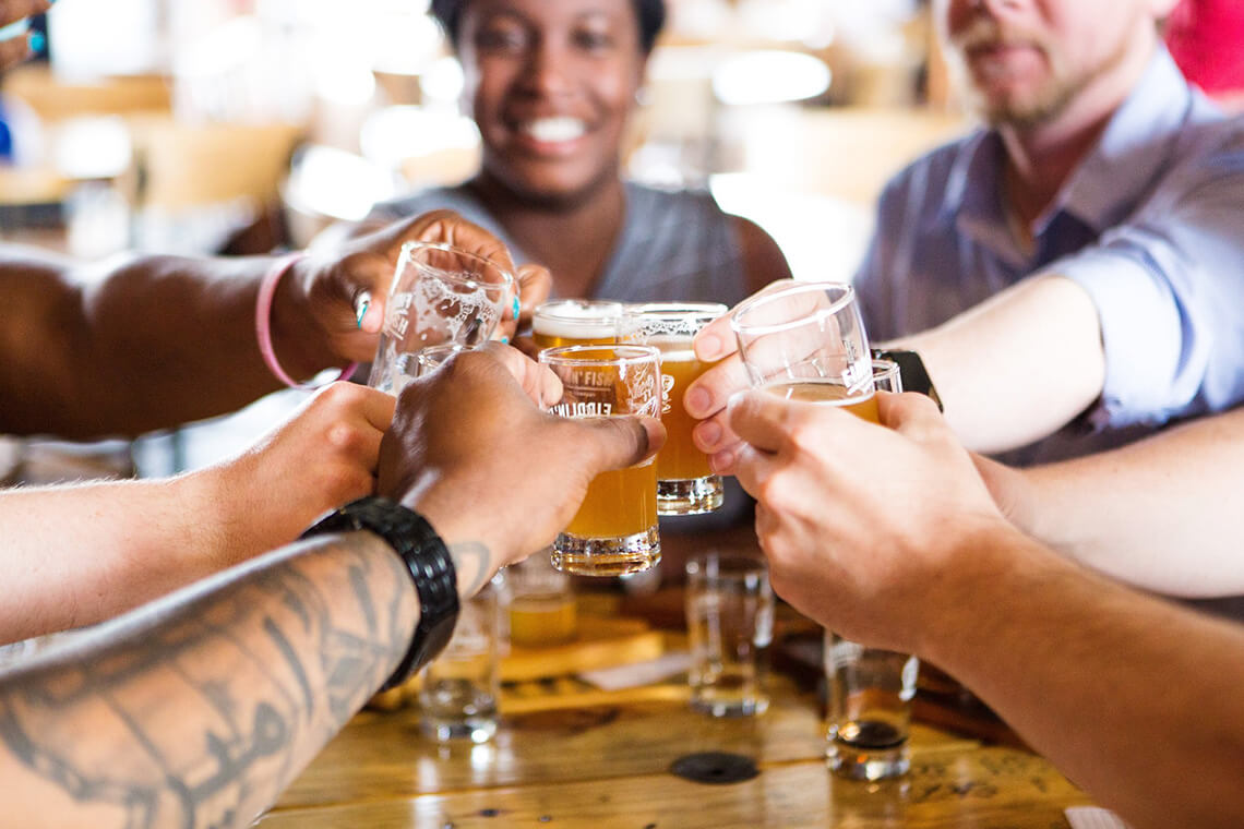 People toast beers at Fiddlin' Fish Brewing Company, a Winston-Salem brewery.