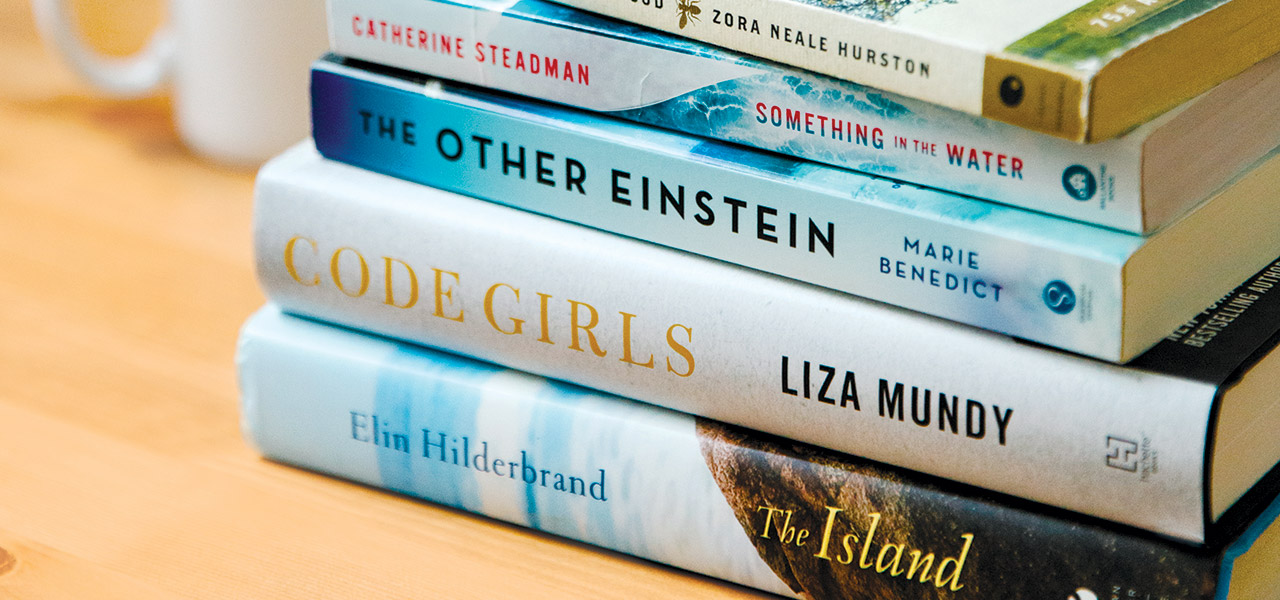 Stack of books: The Island, Code Girls, The Other Einstein, Something in the Water