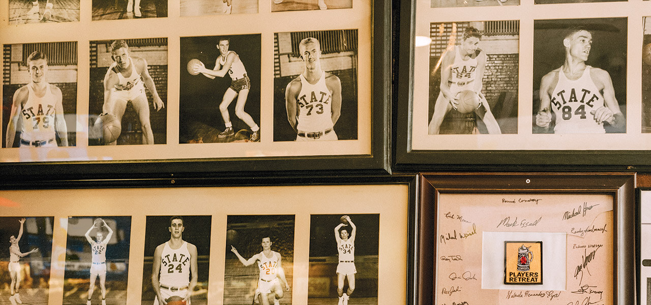 Black-and-white photos of NC State basketball players at the Players Lounge in Raleigh