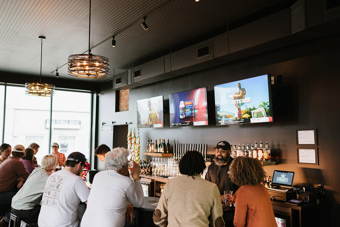 People at the bar at Proximity Brewing Company 