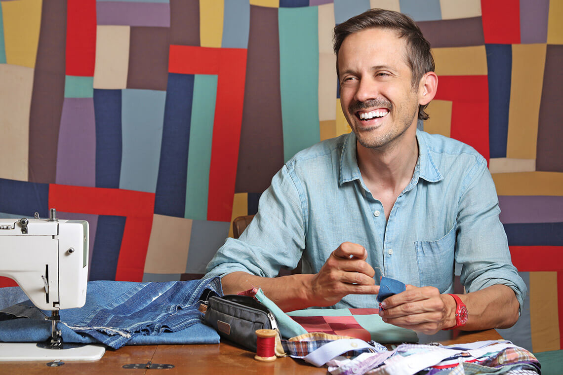 Zak Foster works on a quilt at Olive's Porch in Murphy, NC