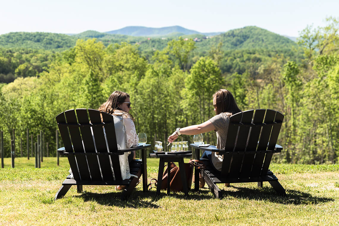 Ladies in chairs at Serre Vineyards in the Yadkin Valley AVA, one of North Carolina's wine regions.
