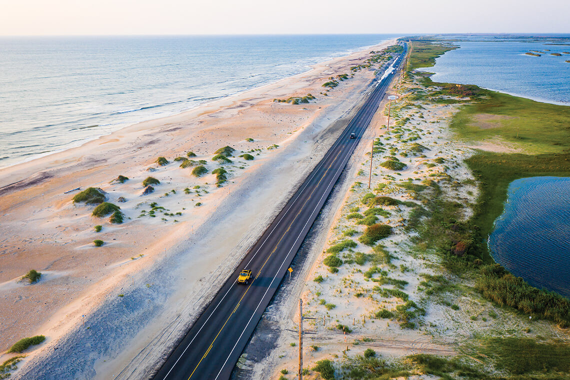 Stretch of NC Highway 12, bordered by the sound and ocean.