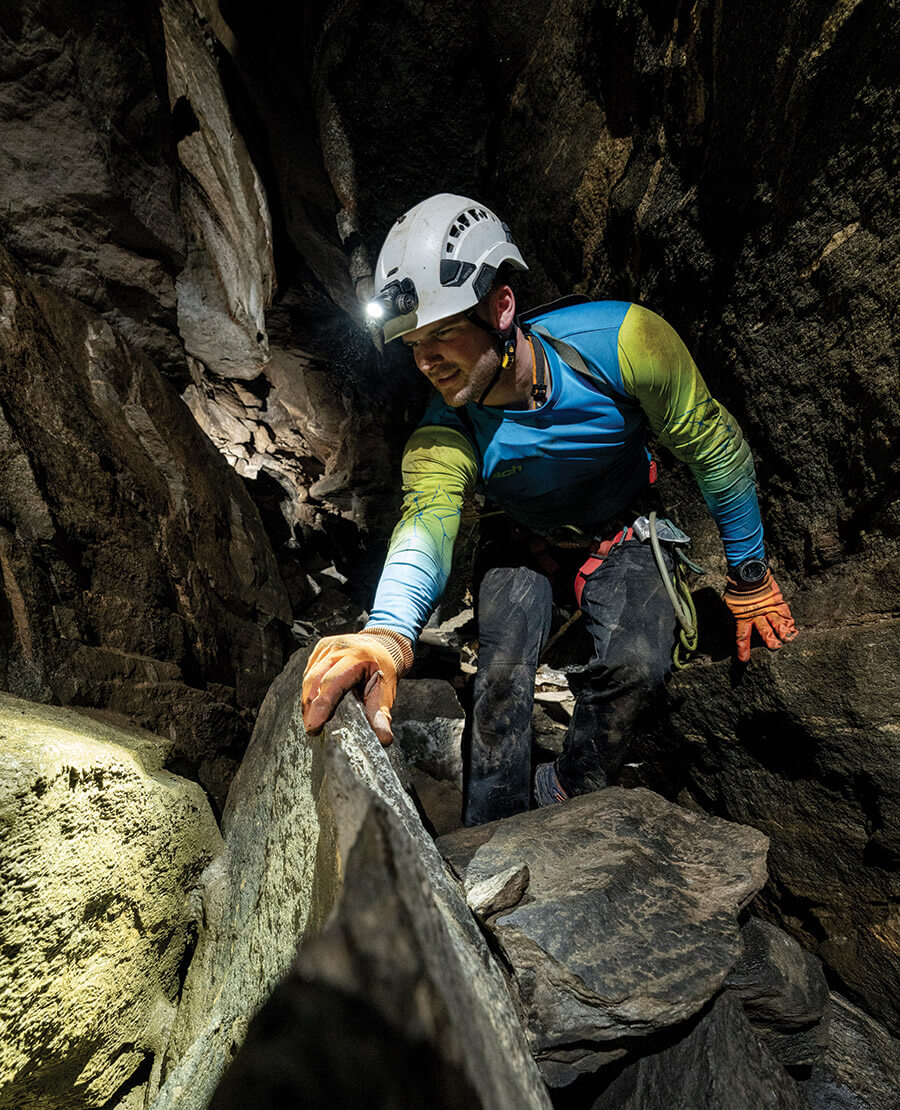 Lemcke climbs through the cave.