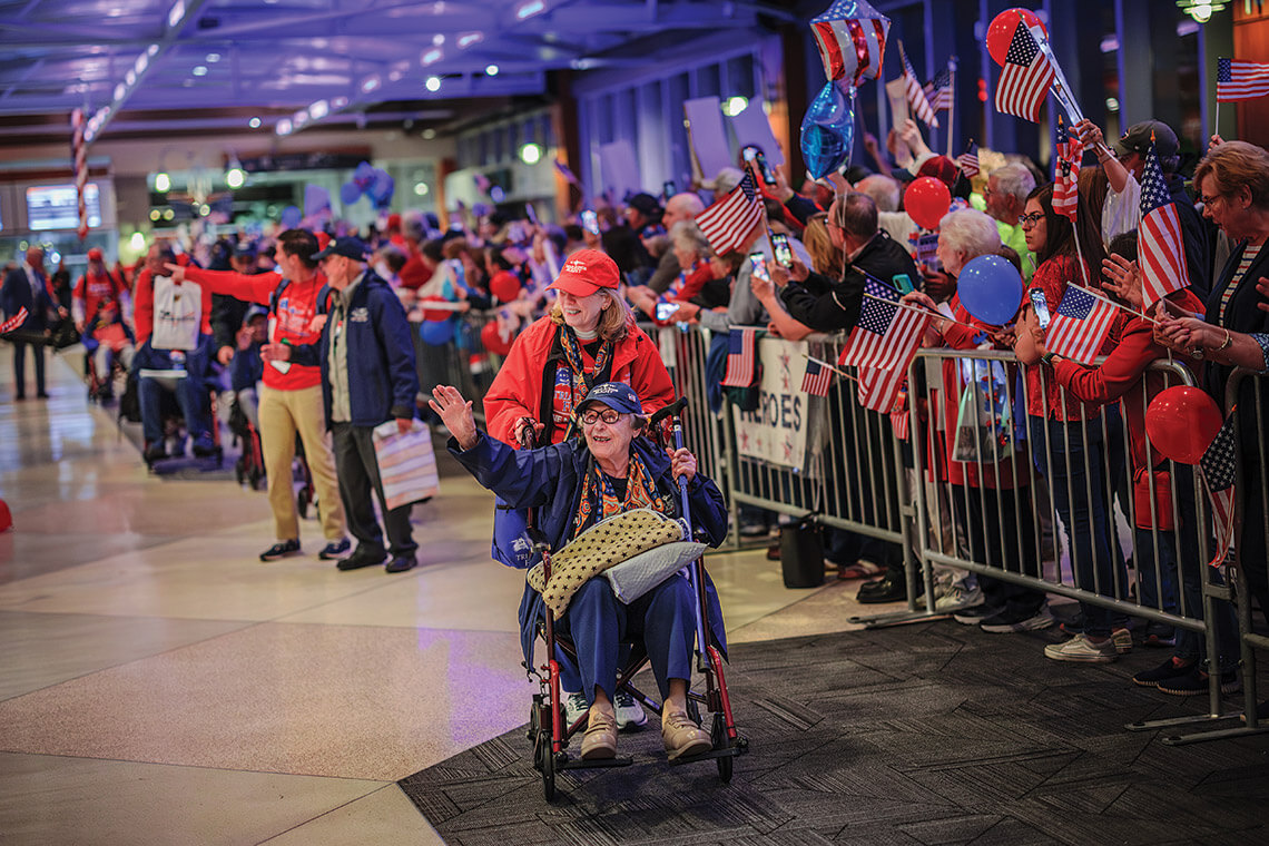 Edna Livengood, a World War II nurse, waves at a crowd after the Triad Honor Flight.