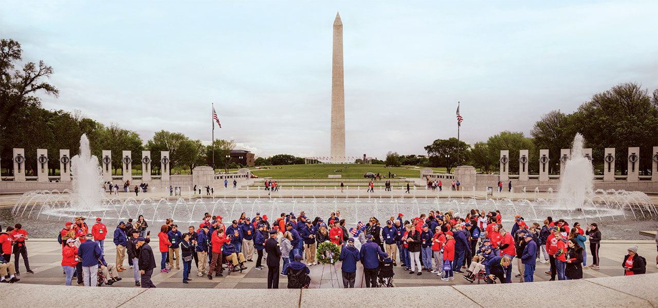 Triad Honor Flight attendees stand at the National Mall