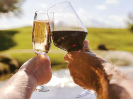 Two people toast their glasses filled with a North Carolina wine.