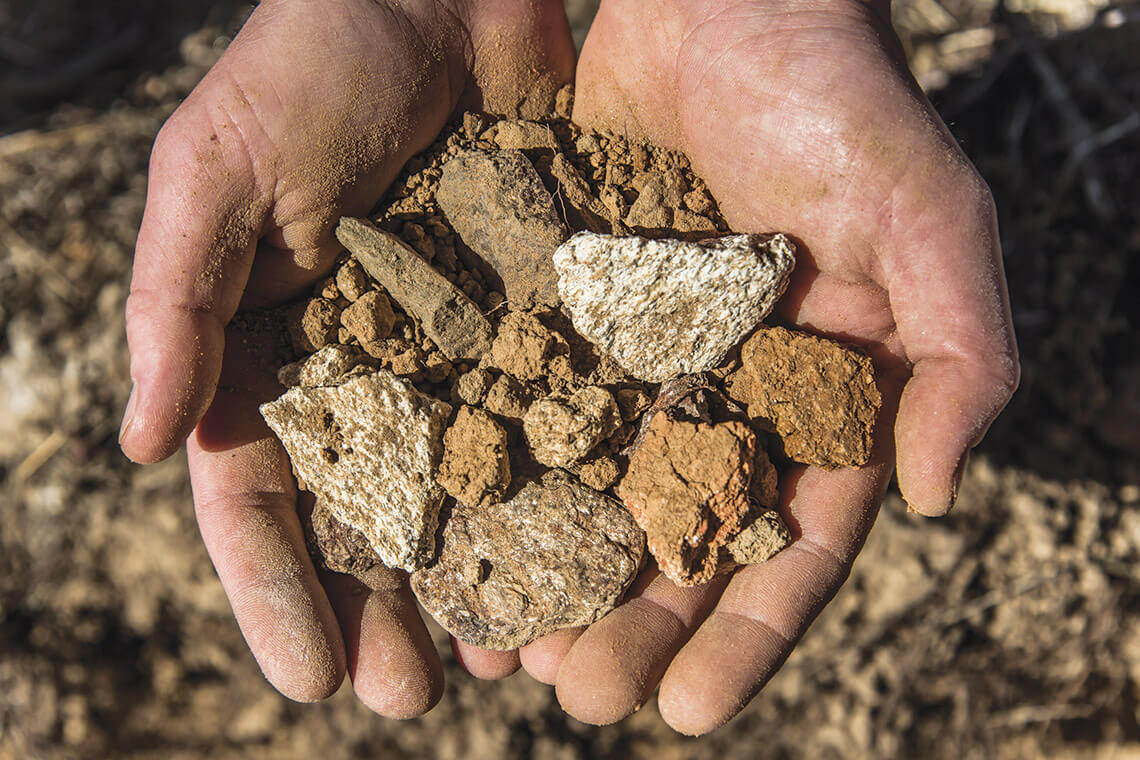 Hands hold gneiss and schist found in the soils around Dynamis Estate Wines, one of the North Carolina wineries.