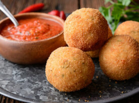 Sausage-stuffed arancini with spicy tomato sauce
