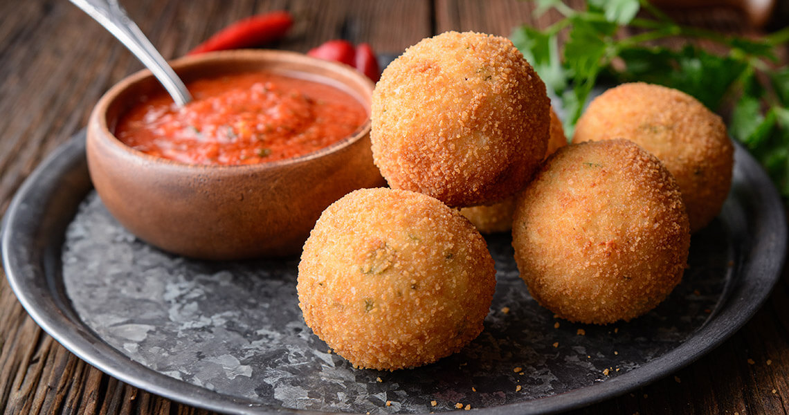 Sausage-stuffed arancini with spicy tomato sauce