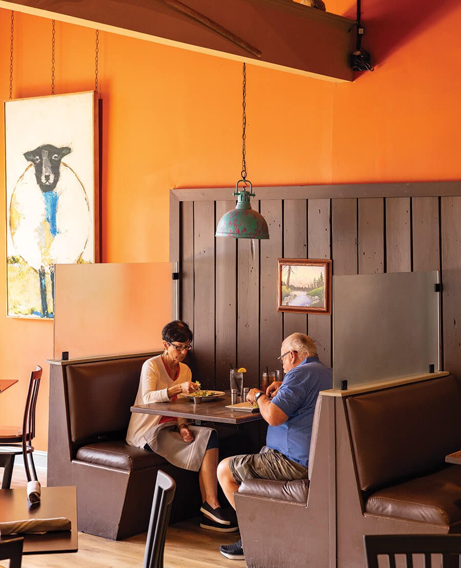 Couple sits at a booth at Birchwood Hall Southern Kitchen