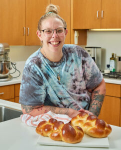 Pepper Segal with two loaves of challah bread
