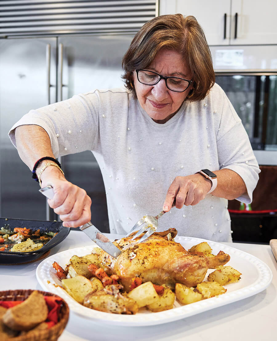 Maria Georgallis carves a roast chicken