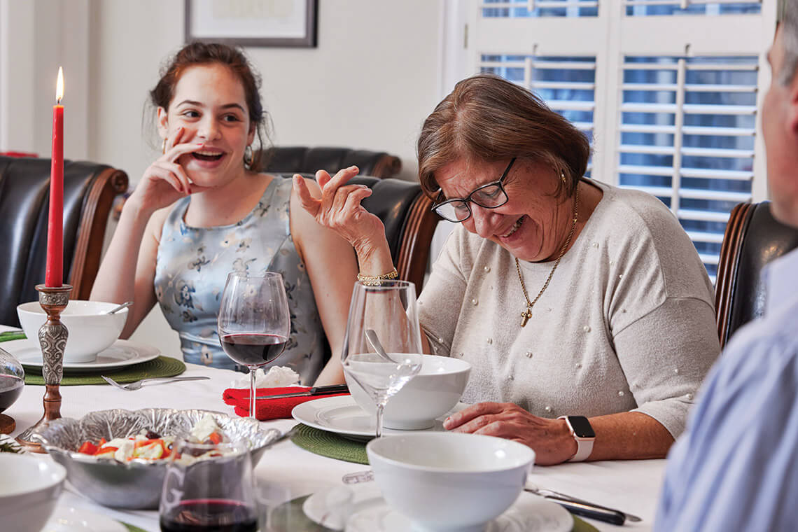 Sofia and Maria Georgallis share a laugh during their Christmas Eve feast.