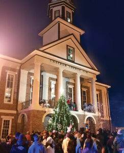 People watch the illumination of the Fraser fir Christmas tree in front of the courthouse in downtown Pittsboro, NC