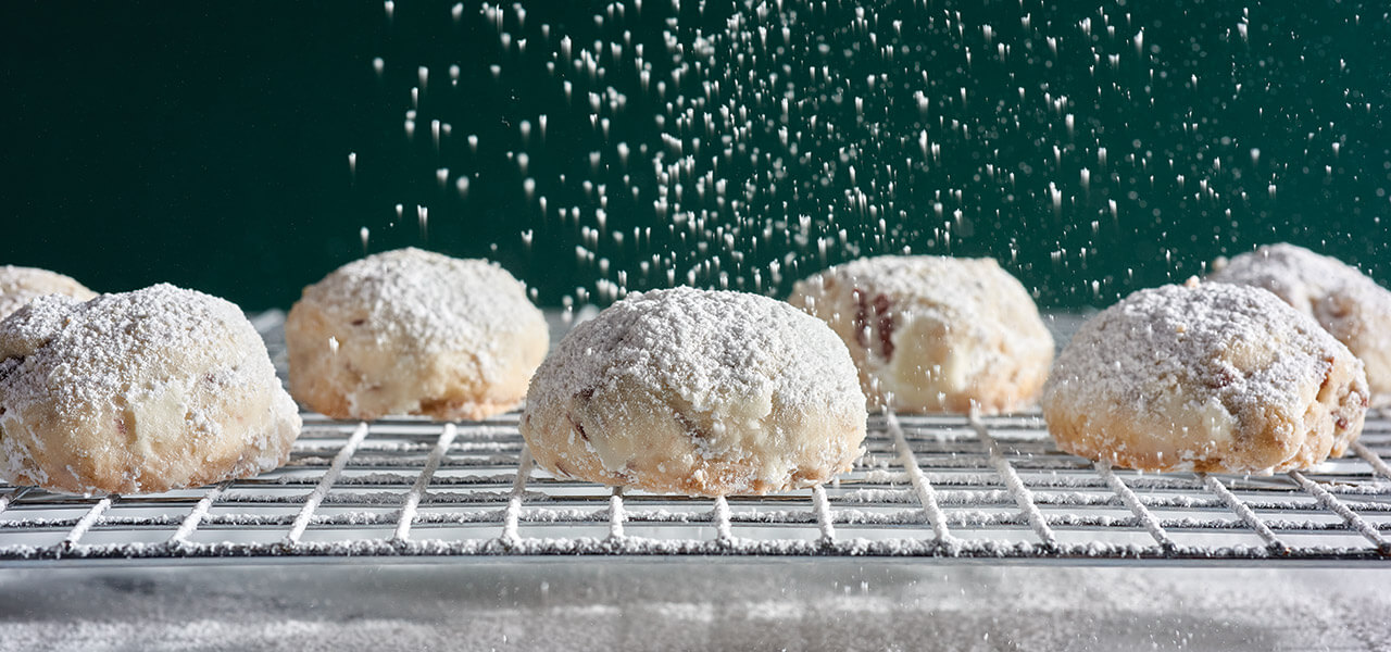Pecan puffs on a cooling rack.