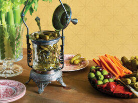 Table with relish tray, celery vase, and pickle castor.