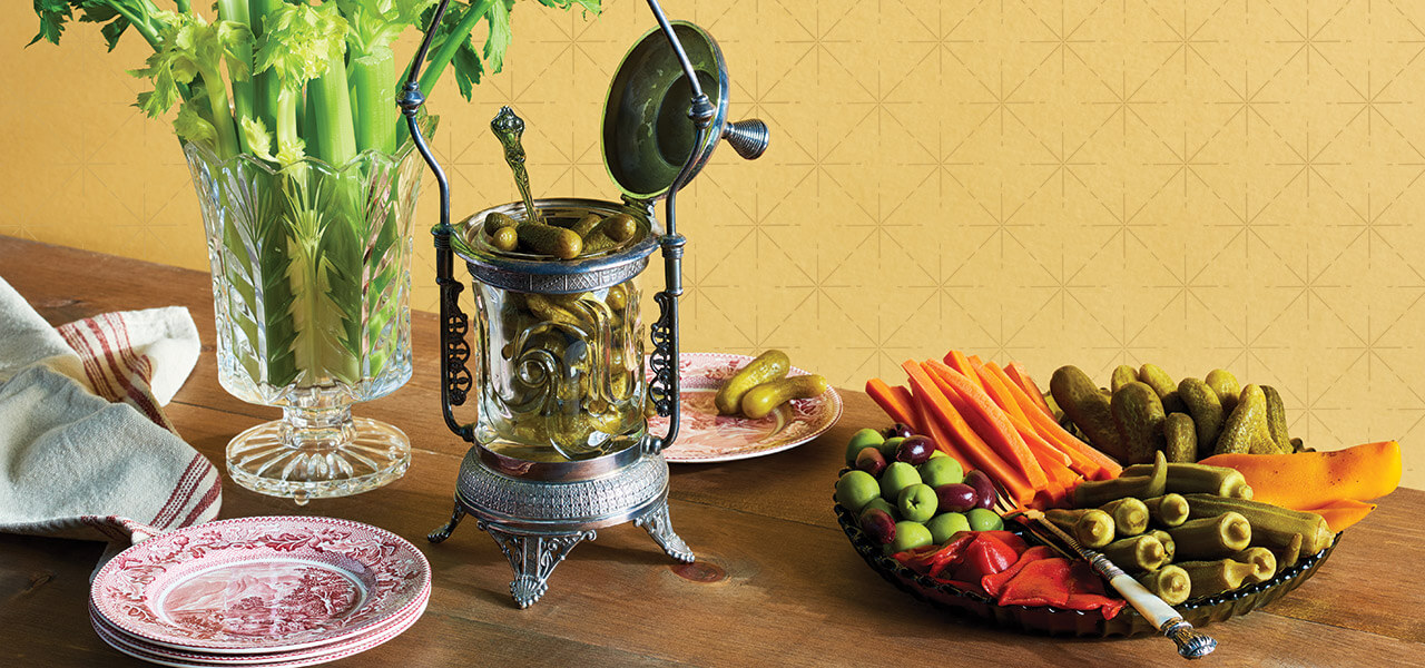 Table with relish tray, celery vase, and pickle castor.