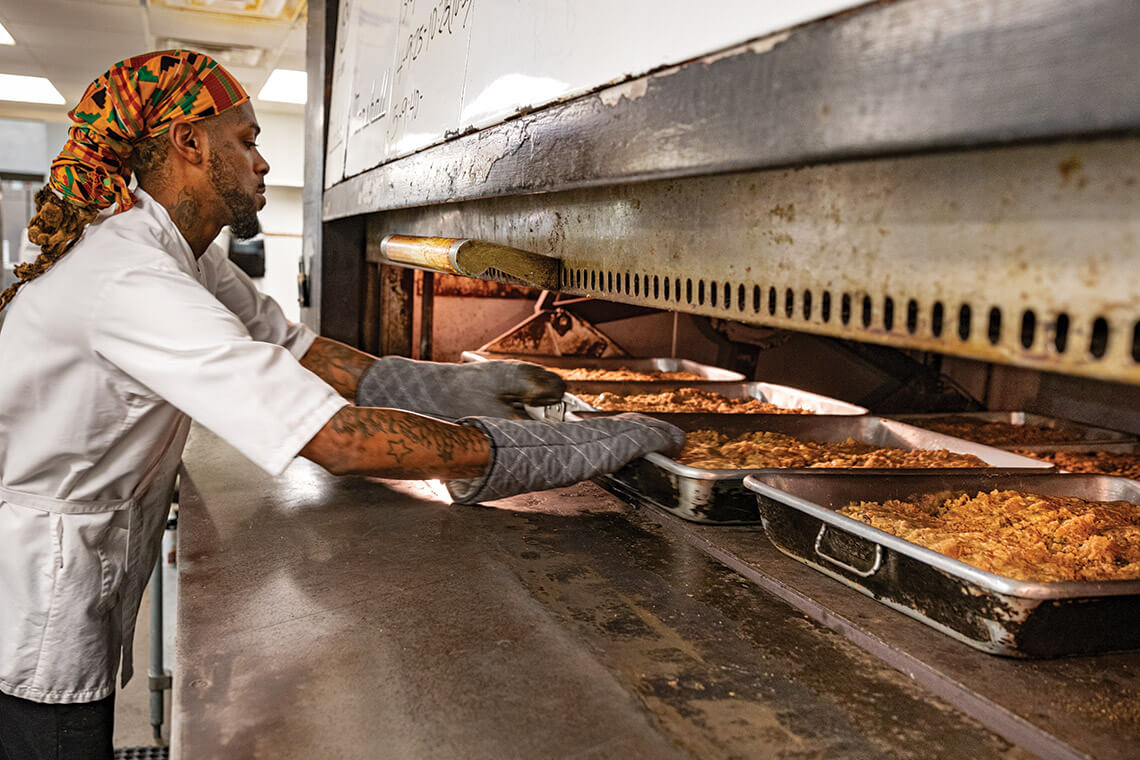 Princeton McAllister prepares batches of fruitcakes at the Southern Supreme company.