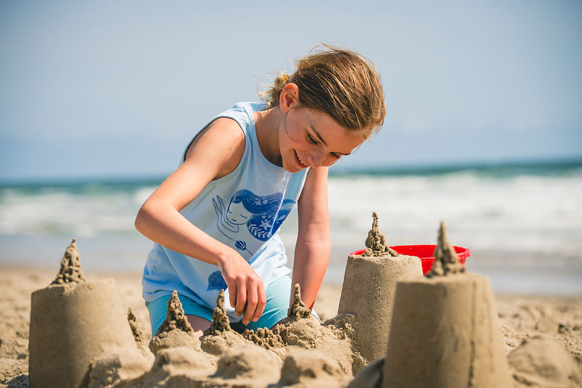 Child builds a sand castle in Corolla, North Carolina