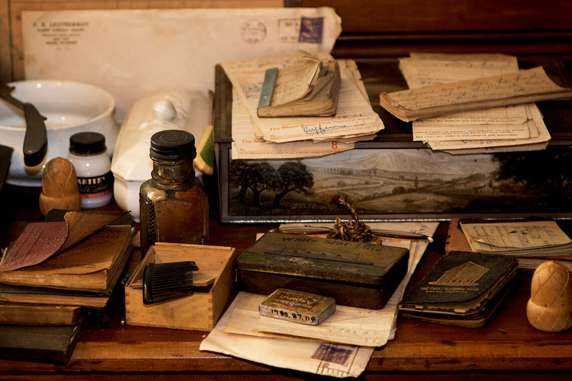 Desk with writings, journals, and books at the Thomas Wolfe House.