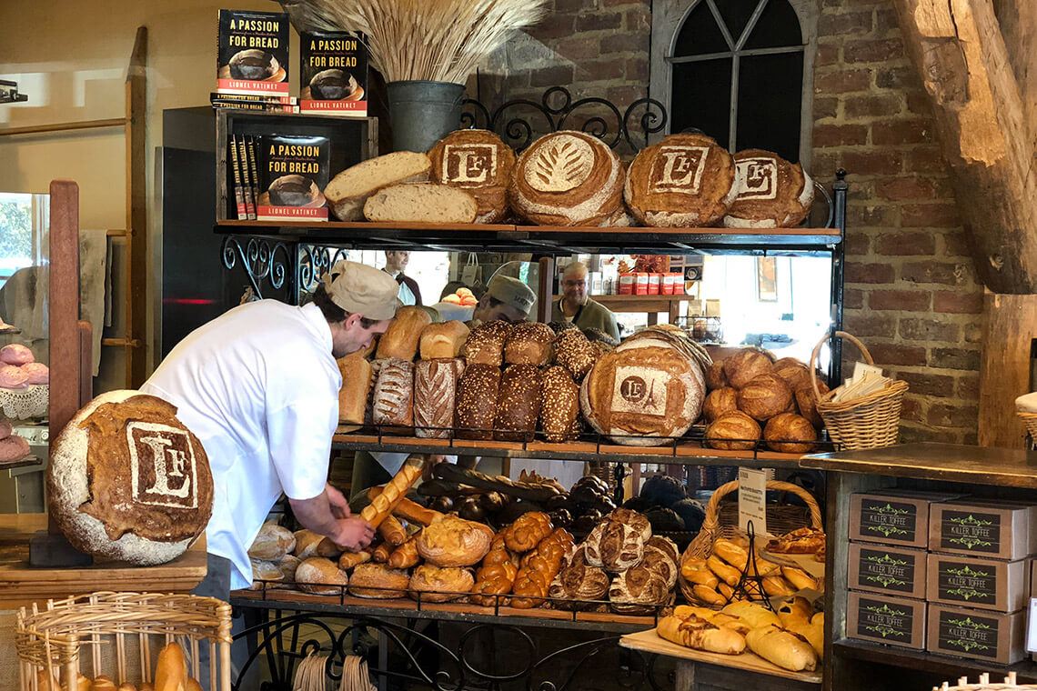 Shelves of fresh bread loaves at Le Farm Bakery in Cary, North Carolina
