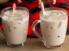 Two cups of Carolina Christmas Punch, garnished with candy canes